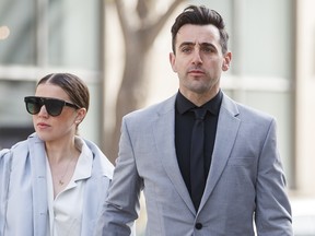 Canadian musician Jacob Hoggard arrives alongside his wife Rebekah Asselstine, for his sex assault trial at the Toronto courthouse on Tuesday, May 10, 2022.