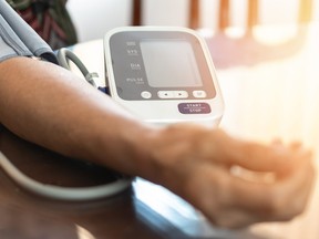 Elderly patient with bp, heart rate, digital pulse check equipment for medical geriatric awareness in stroke systolic high blood pressure, hypertension, hypotension and cardiovascular disease in aged senior older woman person