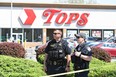 Police stand in front of a Tops Grocery store in Buffalo, New York, on May 15, 2022. (Photo by USMAN KHAN/AFP via Getty Images)