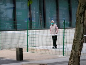 A person walks on a closed street during lockdown, amid the COVID-19 pandemic, in Shanghai, May 16, 2022.