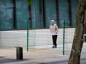 A person walks on a closed road during the lockdown amid the COVID-19 pandemic in Shanghai, May 16, 2022.