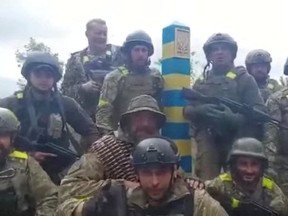 Ukrainian troops stand at the Ukraine-Russia border in what was said to be the Kharkiv region, Ukraine in this screen grab obtained from a video released on May 15, 2022.