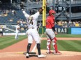 Rodolfo Castro, left, of the Pirates reacts after coming around to score on a run scoring fielders choice off the bat of Ke'Bryan Hayes (not pictured) in the eighth inning during a game against the Reds at PNC Park in Pittsburgh, Sunday, May 15, 2022.