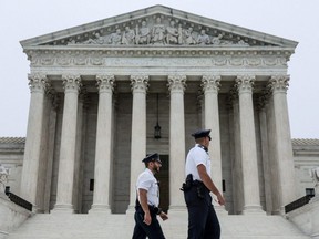 Police officers walk outside the U.S. Supreme Court after the leak of a draft majority opinion written by Justice Samuel Alito preparing for a majority of the court to overturn the landmark Roe v. Wade abortion-rights decision later this year, in Washington, D.C., Tuesday, May 3, 2022.