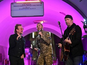 Bono (Paul David Hewson), Irish singer-songwriter, activist, and the lead vocalist of the rock band U2, left, Antytila, a Ukrainian musical band leader and now the serviceman in the Ukrainian Army Taras Topolia, and guitarist David Howell Evans aka 'The Edge' perform at a subway station which is now a bomb shelter, in the centre of Ukraine's capital of Kyiv on May 8, 2022.