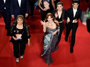 U.S. director and actress Riley Keough (C) waves as she arrives with U.S. actor LaDainian Crazy Thunder for the screening of their film "War Pony" at the 75th edition of the Cannes Film Festival in Cannes, France, on May 21, 2022.