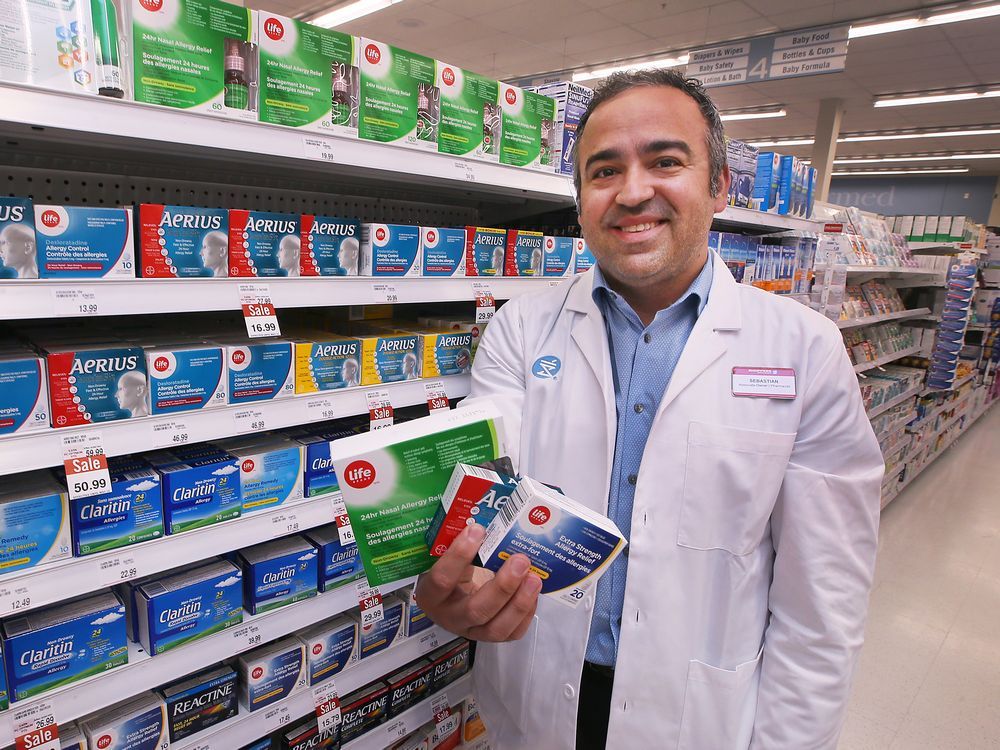 Sebastian DiPietro, an associate owner and pharmacist at the Shoppers Drug Mart at Howard and Tecumseh. displays allergy medication on Tuesday, May 10, 2022.