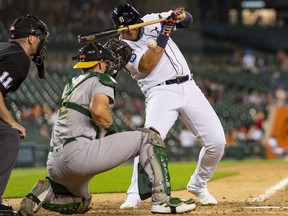 Detroit Tigers designated hitter Miguel Cabrera dodges a pitch high and inside from Oakland Athletics relief pitcher Justin Grimm (not pictured) during the ninth inning at Comerica Park.