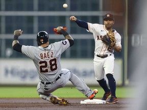 Houston Astros second baseman Jose Altuve turns a double play on Detroit Tigers shortstop Javier Baez and right fielder Robbie Grossman (not pictured) in the first inning at Minute Maid Park.