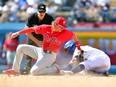 Los Angeles Dodgers left fielder Chris Taylor steals second against Philadelphia Phillies shortstop Bryson Stott during the seventh inning at Dodger Stadium.  The call would be overturned on video review challenge.
