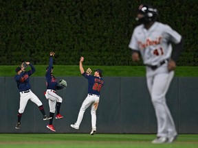 Minnesota Twins left fielder Gilberto Celestino, centre fielder Byron Buxton, and right fielder Max Kepler celebrate a victory over the Detroit Tigers by taking imaginary jump shots at Target Field.