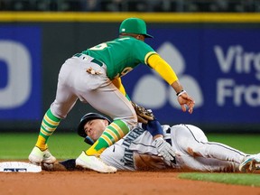 Oakland Athletics second baseman Tony Kemp tags out Seattle Mariners second baseman Adam Frazier on a stolen base attempt during the first inning at T-Mobile Park.