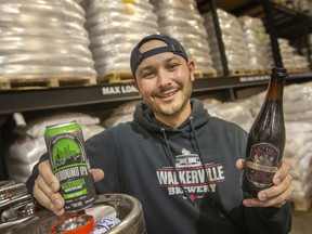 Sammy McLean, a brewer at Walkerville Brewery, holds up the Geronimo IPA and the Russian Imperial Stout, which both won silver the recent Canadian Brewing Awards, while at the brewery on Wednesday, May 18, 2022.