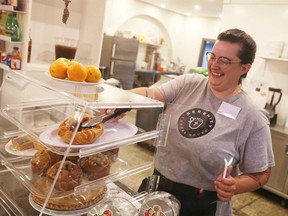 Michaela Walda, supervisor at Serenity Coffee House in Ford City, serves a Danish pastry on Saturday, May 21, 2022.