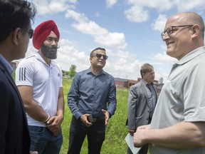 Let's play cricket. Harjeet Singh, from left, Dave Patel, of the Windsor-Essex Cricket League, Ward 8 Coun. Gary Kaschak and Mayor Drew Dilkens are shown at Derwent Park on Friday, May 27, 2022, site of a proposed full-sized cricket pitch.