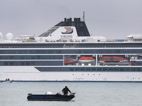 Big and little. An angler is shown on the Detroit River on Tuesday, May 3, 2022, near the Viking Octantis cruise ship that was docked on the American side of the waterway near the Ambassador Bridge. Cruise ships are visiting the Great Lakes for the first time since the fall of 2019.