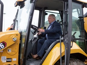 Ontario Premier Doug Ford posed for a photo at a construction site in Brampton on the first day of the Ontario election campaign (May 4, 2022).