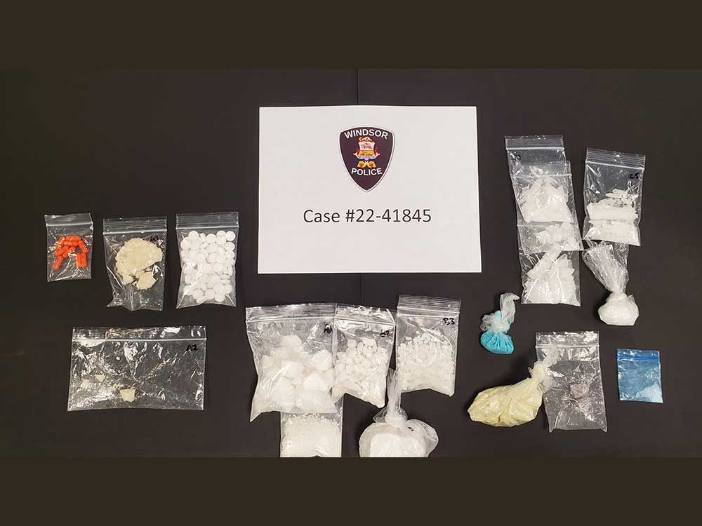 An evidence photo showing cocaine, crack cocaine, methamphetamine, fentanyl, Percocet pills, and Hydromorph Contin pills - seized by Windsor police during a vehicle stop on May 17, 2022.