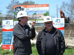 Essex Coun. Chris Vander Doelen, left, speaks Tuesday, May 10, 2022, with Mayor Richard Meloche at the site of the Grove Retro Motel in the village of Colchester. Construction is underway at the site.