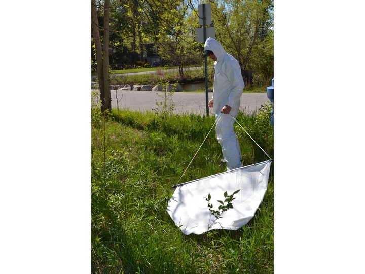  Joel Barrington, public health inspector with the Windsor Essex County Health Unit, conducts an active tick surveillance by dragging a special, flannel-like material through the tall grass at Ojibway Park, Friday, May 13, 2022.