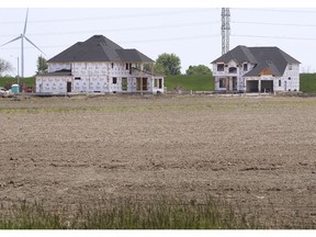 LAKESHORE, ONTARIO. MAY 20, 2021 - New homes under construction near farmland  just east of the Renaud Line is shown on Thursday, May 20, 2021. Ontario growers are worried over the rapid pace of disappearing farmland due to urban sprawl.