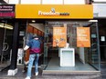 A man enters the store at the new rebranding sign of Freedom Mobile in Toronto on Nov. 24, 2016.