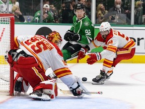 Calgary Flames goaltender Jacob Markstrom stops a shot as defenseman Oliver Kylington and Dallas Stars centre Vladislav Namestnikov look on during the third period in game six of the first round of the 2022 Stanley Cup Playoffs at American Airlines Center.