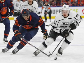 Los Angeles Kings defensemen Troy Stecher and Edmonton Oilers forward Evander Kane  chase a loose puck during the third period in game seven of the first round of the 2022 Stanley Cup Playoffs at Rogers Place.