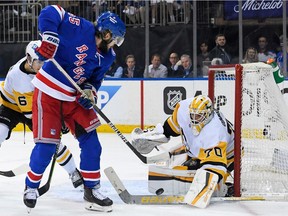 Pittsburgh Penguins goaltender Louis Domingue makes a save on New York Rangers defenseman Ryan Lindgren during the second period in game five of the first round of the 2022 Stanley Cup Playoffs at Madison Square Garden.