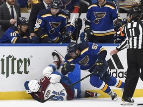 May 23, 2022; St. Louis, Missouri, USA; St. Louis Blues left wing David Perron (57) hits Colorado Avalanche center Nazem Kadri (91) during the second period in game four of the second round of the 2022 Stanley Cup Playoffs at Enterprise Center.