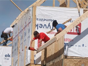 Construction workers are shown framing a house near McHugh Street and Lauzon Road in Windsor on Thursday, May 19, 2022.