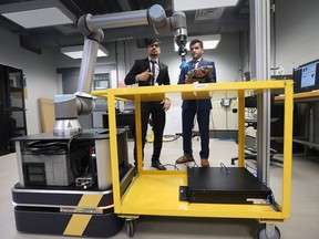 Winners Yash Soni, left, and Deual Patel, electromechanical-robotics engineering students, compete in the Ford Innovation Showcase competition Friday, May 6, 2022 on the main campus of St. Clair College.