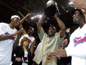 Chauncey Billups, Rasheed Wallace, President of Basketball Operations Joe Dumars (holding trophy) and Ben Wallace of the Detroit Pistons celebrate their win over the Indiana Pacers in Game six of the Eastern Conference Finals during the 2004 NBA Playoffs at The Palace of Auburn Hills on June 1, 2004 in Auburn Hills, Michigan.  The Pistons defeated the Pacers 69-65 and won the 2004 Eastern Conference Championship.