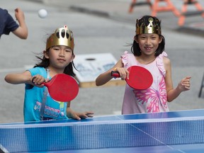 Evaothii Nguyen and sister Olivia play ping pong on the first day of Amherstburg Open Air Weekends, Saturday, May 21, 2022.