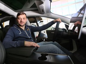 University of Windsor professor Francesco Biondi is shown behind the wheel of a Tesla on campus on Tuesday, May 17, 2022.