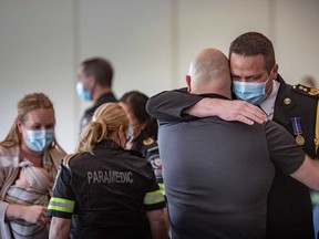 Heart attack survivor Kyle Tazzman (right) embraces Essex-Windsor EMS member Tyson Brohman at the 9th annual Survivor Day celebration at the St. Clair College Centre for the Arts in Windsor on May 27, 2022.
