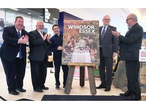Gordon Orr, CEO of Tourism Windsor Essex Pelee Island, left, Chris Savard, GM Devonshire Mall, Nelson Santos, Chair of Tourism Windsor Essex, Drew Dilkens, Mayor of Windsor and Gary McNamara, Warden, County of Essex unveil the official visitor guide during a press conference on Wednesday, May 11, 2022 at the Devonshire Mall.