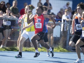 Holy Names Knights sprinter Semi Mugenzi competes in the men's junior 200 meters during Thursday's WECSSAA track and field championships at Sandwich High School.