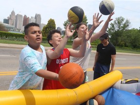 Isaiah Lake, left, Jayden Stephens and Makayla Diamond shoot some hoops at Windsor's 130th birthday party downtown on Saturday, May 21, 2022.
