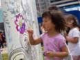 Happy Birthday! Seline Qu, age five, helps paint a Riverside Optimist Club mural at a downtown celebration for Windsor's 130th birthday on Saturday, May 21, 2022.