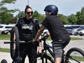 Aidin Valley, age 12, talks with a LaSalle police officer during the department's 25th annual bike rodeo on Saturday, June 4, 2022.