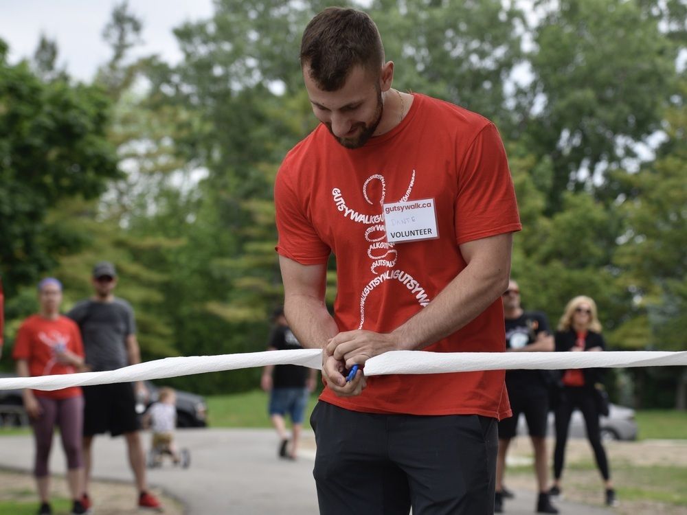  dante fantin, honorary chair of this years gutsy walk for crohn’s and colitis canada, cuts the toilet-paper ribbon to kick off gutsy walk on sunday, june 5, 2022.