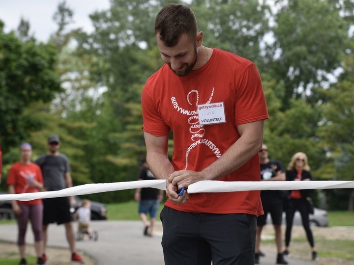  Dante Fantin, honorary chair of this years Gutsy Walk for Crohn’s and Colitis Canada, cuts the toilet-paper ribbon to kick off Gutsy Walk on Sunday, June 5, 2022.