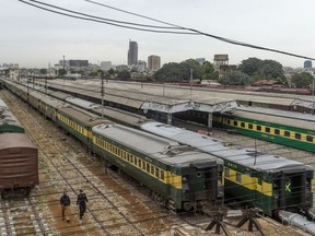 Policemen walk along trains stationed on a deserted platform at Karachi Cantonment railway station during a government-imposed nationwide lockdown as a preventive measure against the COVID-19 coronavirus in Karachi on March 26, 2020. (Photo by ASIF HASSAN/AFP via Getty Images)