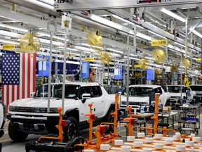 FILE PHOTO: Hummer EV are seen on the production line as U.S. President Joe Biden tours the General Motors 'Factory ZERO' electric vehicle assembly plant, in Detroit, Michigan, U.S. November 17, 2021.