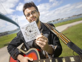 Austin Di Pietro, one half of Windsor indie-folk duo The Bishop Boys, holds a copy of the band's debut album: Old Friends, Brief Ends. Released June 2022 by Soul City Music Co-Op.