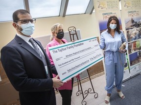 Windsor Regional Hospital chief of staff Dr. Wassim Saad, Beth Ann Prince, chair of the Windsor Regional Hospital Foundation, and Lisa Tayfour, from the Tayfour Family Foundation, hold up a $250,000 donation cheque from Dr. Fouad Tayfour and Dr. Barry Emara at Windsor Regional Hospital's Ouellette campus on Wednesday, June 1, 2022.