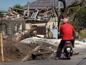 A man pauses to look at a home that was recently damaged by a Russian missile strike on June 19, 2022 in Druzhkivka, Ukraine.