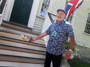 Don Wilson, president of Les Amis Duff-Baby, cuts the ribbon on the 224-year-old west-end Duff-Baby Mansion on its first day of public tours in years Saturday, June 11, 2022.