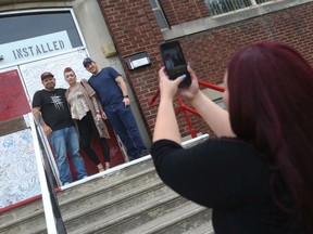 Forster Secondary School alumni Joe Entwistle (left), Rebecca Entwistle (centre), and Wesley Brewer pose for a photo during a celebration of the west-end school’s 100th anniversary on Saturday, June 11, 2022.